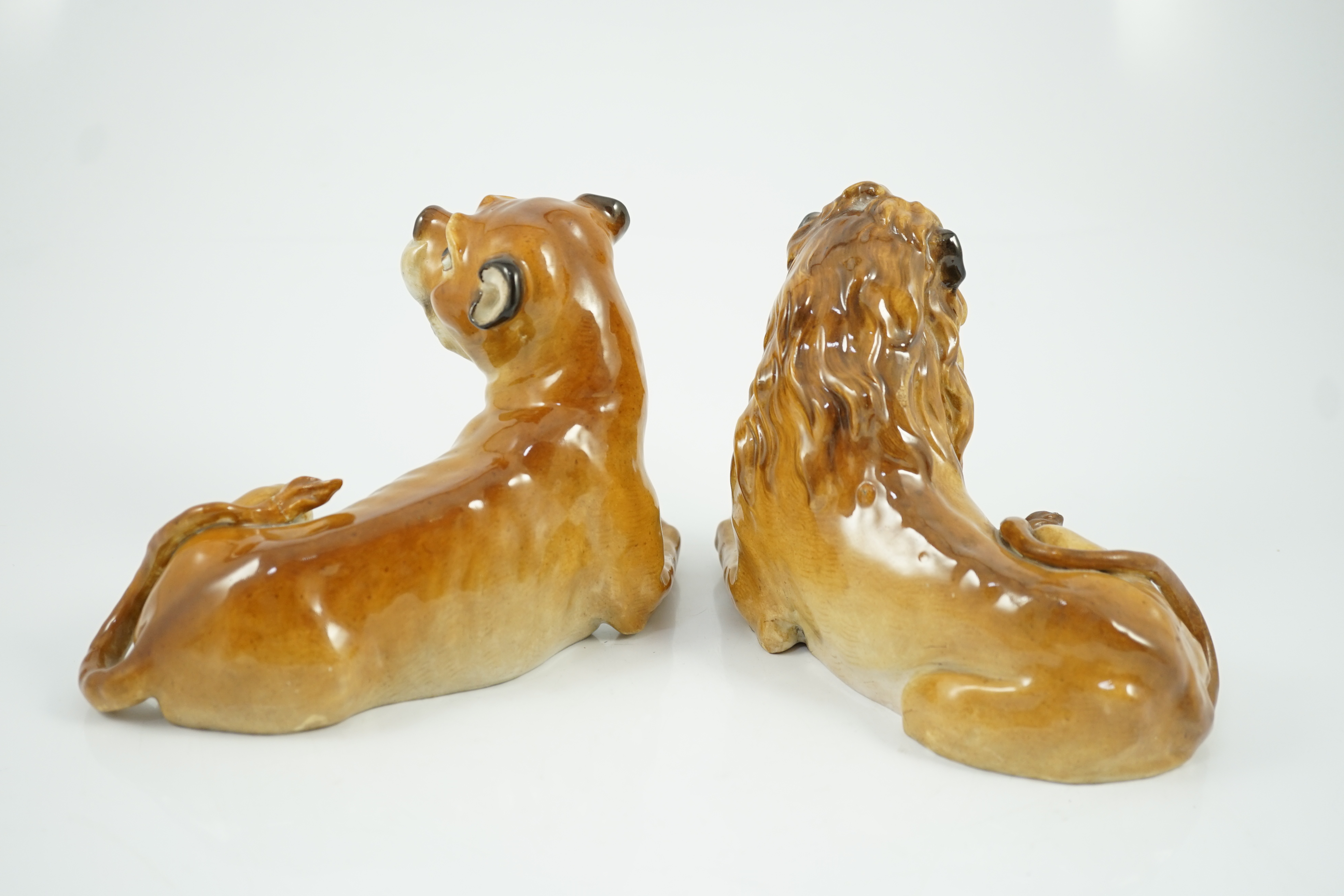 A pair of Meissen figures of a recumbent lion and lioness, 19th century, restoration